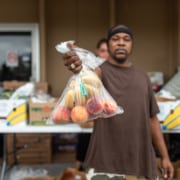 Emergency Food and Shelter Program, man holding bag of fruit