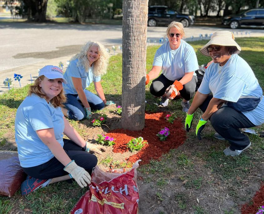 four women work on landscaping