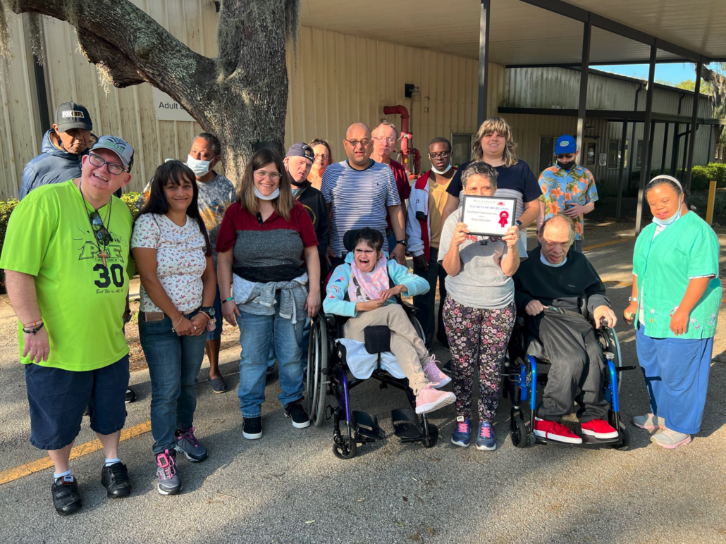 Group of adults in the program smiling at the camera. 