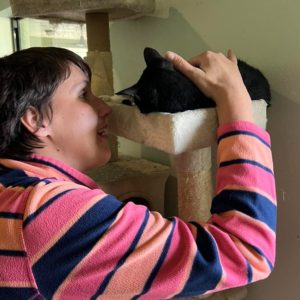 woman pets cat at Humane Society